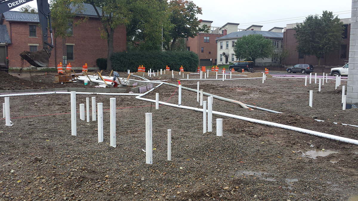 Pipes sticking out of the ground in a construction site in Lexington KY for radon mitigation